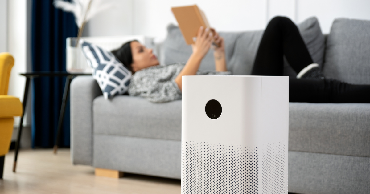 woman relaxing at home with an air purifier